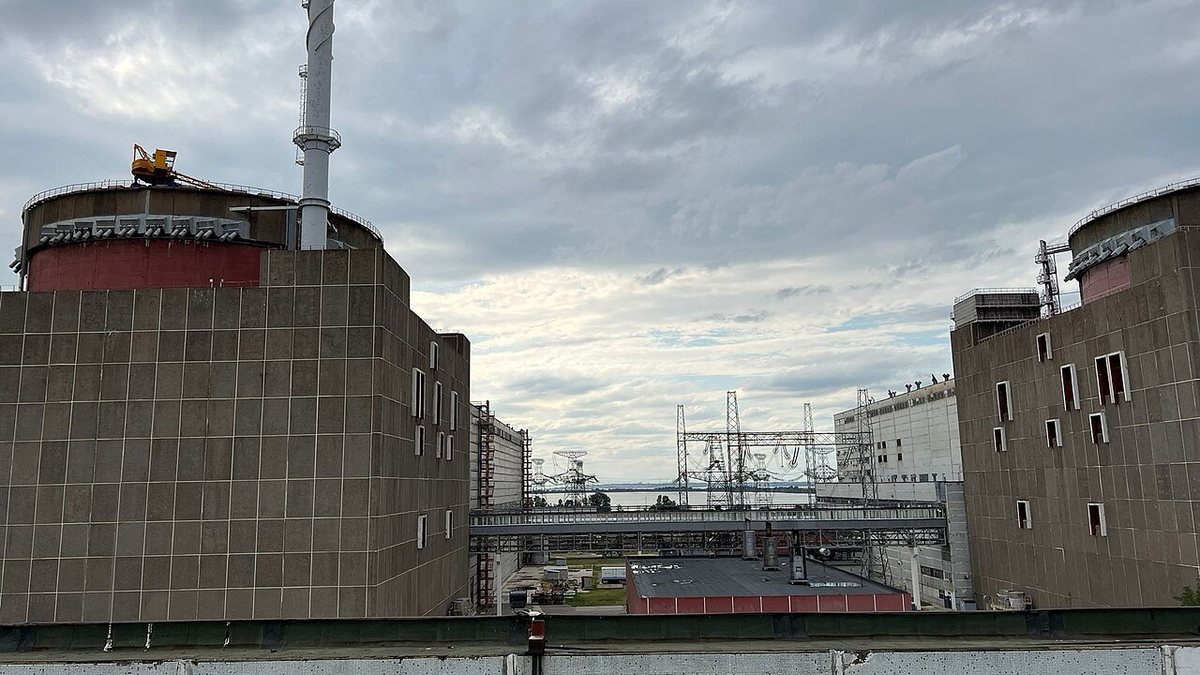 Reactor buildings and power transmission towers at the Zaporizhzhia Nuclear Power Plant under a cloudy sky, IAEA file photo from 2022