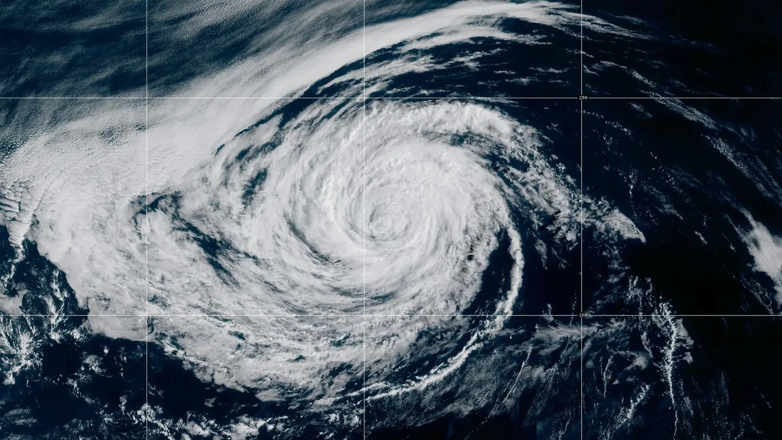 GOES-18 GeoColor satellite image of Tropical Storm Rachel at 1 PM EDT Oct 8, 2026: a broad spiral of cloud with a ragged centre over the open eastern Pacific, about 915 miles west of the southern tip of Baja California.