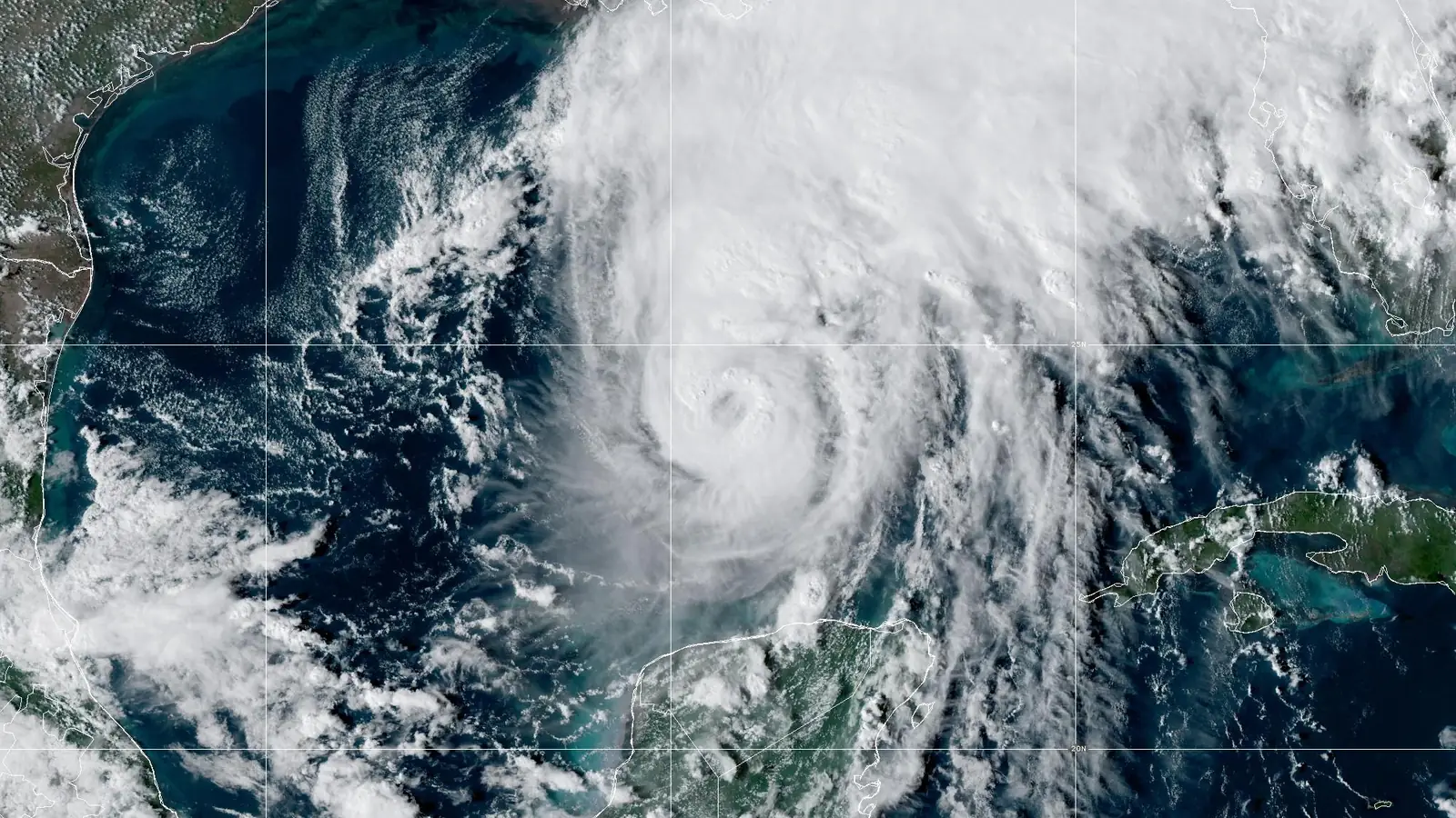 GOES-19 GeoColor satellite image of Hurricane Isaias at 5 PM EDT Oct 8, 2026 (NHC Advisory 9): a small eye in a dense, round core over the southern Gulf of Mexico, with a broad cloud shield spreading northeast over the Florida Panhandle.