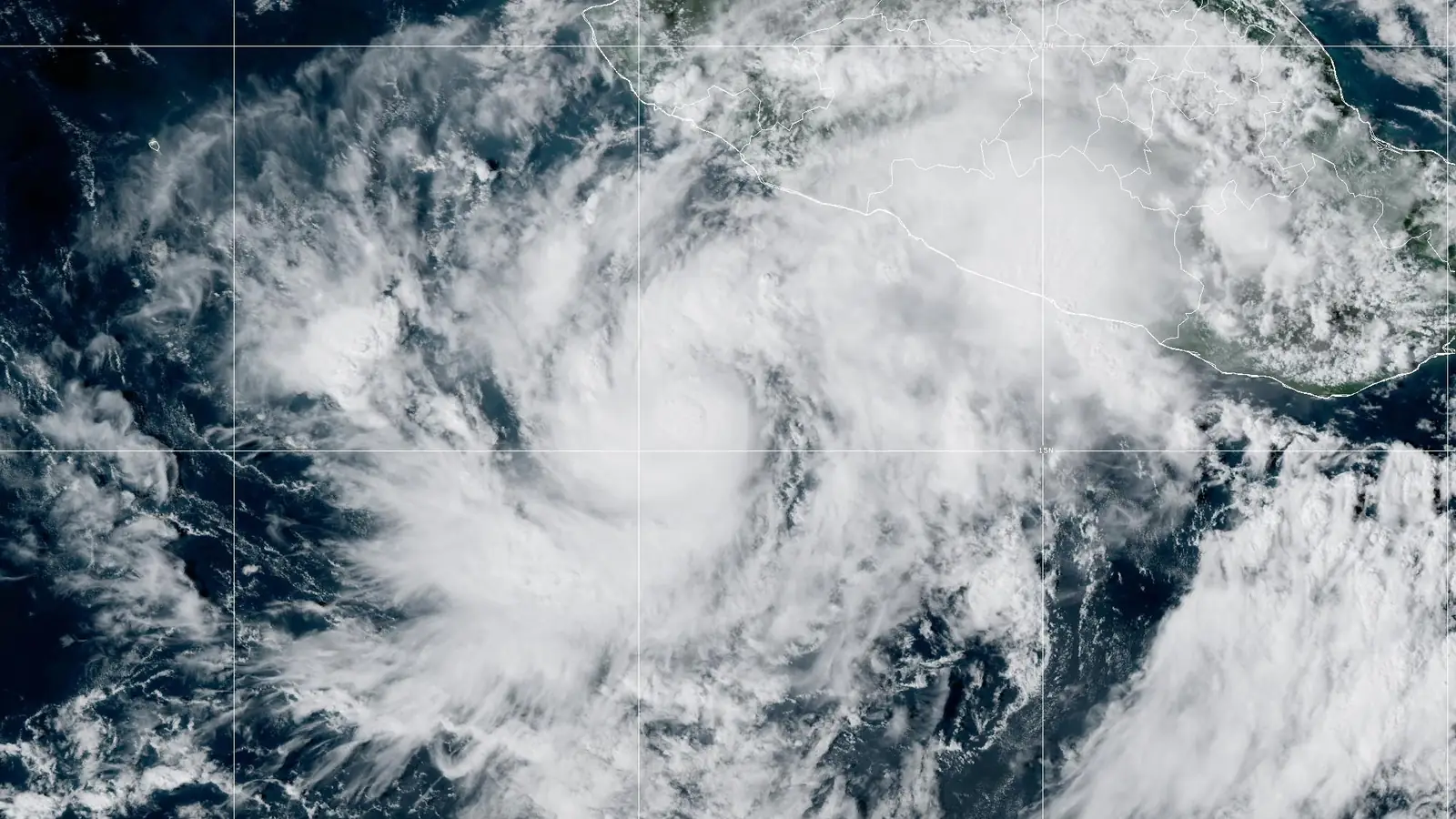 GOES-19 GeoColor satellite image of Tropical Storm Simon at 5 PM EDT Oct 8, 2026 (NHC Advisory 6): a compact core of dense cloud over the eastern Pacific, with spiral bands reaching the coast of southwestern Mexico.
